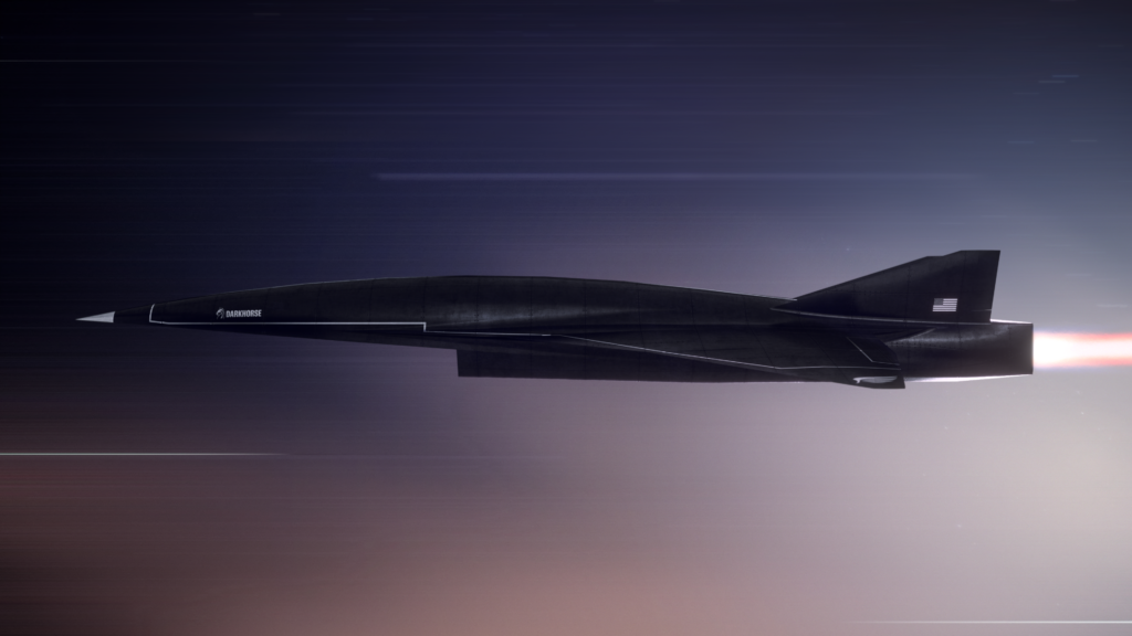 Conceptual rendering of the Hermeus hypersonic aircraft in flight, featuring a sleek, dark fuselage with an aerodynamic design and a rear jet propulsion system, set against a blurred background, indicating high speed.